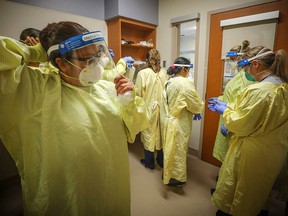 Nurses prepare to treat a COVID-19 patient on the intensive care unit at Peter Lougheed Centre in Calgary on Nov. 14, 2020. LEAH HENNEL/Alberta Health Services