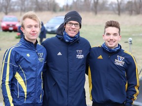 Laurentian Voyageurs cross-country coach Darren Jermyn, centre, poses with Sudbury products and LU grads Liam Passi, left, and Caleb Beland.