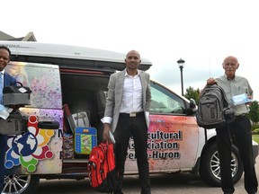 Volunteers with the Multicultural Association of Perth Huron are collecting donations of backpacks, school supplies, clothing and other necessities to give to local newcomer kids and other students in need as they prepare to head back to school in September. Pictured from left are multicultural association founder Dr. Gezaghn Wordofa, volunteer and board member Emmanuel Munisi, and volunteer Steve Landers. Galen Simmons/Postmedia Network
