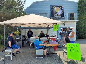 Elks members braved a hot humid day, serving up hot dogs, hamburgers and sausages on Saturday, Aug. 21 all for a good cause. Pat Luopa, Jack Luopa, Sheri Commission, Danny Tobodo, Russ VanderJagt. Eager customers were Debbie and Mark Langlois and Tony Bordonaba.