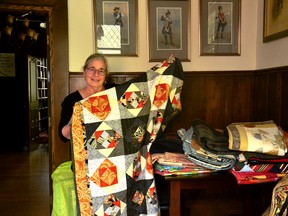 Amanda Ryan, a retired seamstress and set designer with the Stratford Festival, shows off one of the quilts she stitched together while stuck inside during the COVID-19 pandemic. With 21 in total, Ryan will be selling her quilts during the PAL Stratford Quilt Show and Sale fundraiser from 9 a.m. to 5 p.m. Aug. 30 at 101 Brunswick Street. Galen Simmons/The Beacon Herald/Postmedia Network