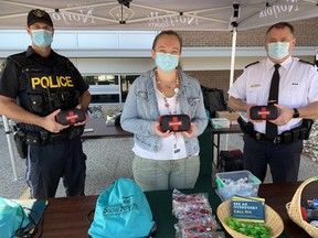 Representatives of the Norfolk OPP and the Haldimand-Norfolk Health Unit marked International Overdose Awareness Day in Simcoe Tuesday with an open house at detachment headquarters in Simcoe. Among those participating -- from left – were Const. Barry Yantha, public health nurse Kate McInnis, and Insp. Rob Scott, interim chief of the Norfolk OPP. – Monte Sonnenberg