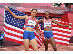 Sydney Mclaughlin (L) and Dalilah Muhammad of the U.S. celebrate winning gold and silver respectively in the women's 400-metre hurdles final at the Tokyo 2020 Olympic Games.