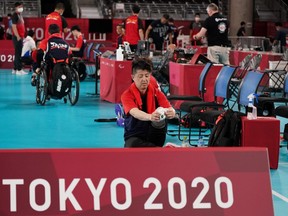 Yoshihiro Iikura of Team Japan prepares to wear his prosthesis leg after a Sitting Volleyball training session ahead of the Tokyo 2020 Paralympic Games at the Makuhari Messe Hall A on August 23, 2021 in Tokyo, Japan. (Photo by Toru Hanai/Getty Images for International Paralympic Committee)