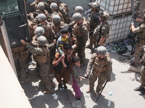Marines and Norwegian coalition forces assist with security at an Evacuation Control Checkpoint ensuring evacuees are processed safely during an evacuation at Hamid Karzai International Airport, Kabul, Afghanistan, Aug. 20, 2021.