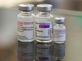 Three vials with different vaccines against COVID-19 by (L-R) Moderna, AstraZeneca and Pfizer-BioNTech.
