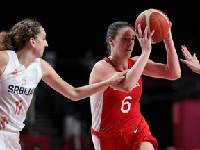 Canada's Bridget Carleton of Chatham, Ont., dribbles past Serbia's Aleksandra Crvendakic in a women's basketball preliminary-round game during the Tokyo Olympic Games at the Saitama Super Arena in Saitama on July 26, 2021. (Photo by THOMAS COEX/AFP via Getty Images)