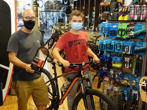 Stephen Strachan and Conner with his new bike inside The Hardwear Company.