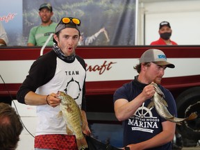 Demers (right) and Waterer showing off their Day 3 haul during the Top 10 parade through the Whitecap Pavilion.
