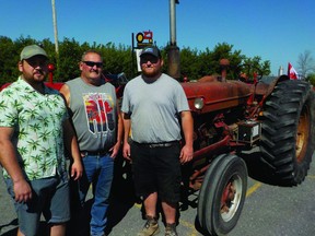 Samuel, Sylvain, and Israel Quenneville showed their solidarity with the farming community