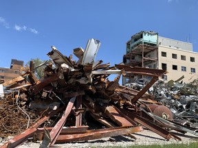Piles of debris lie on the site of the former St. Vincent de Paul Hospital site on Monday, with only the main tower left to take down. (RONALD ZAJAC/The Recorder and Times)