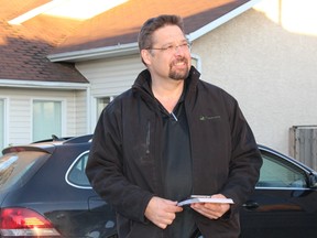 David Yurdiga, Fort McMurray-Cold Lake's Conservative candidate, listens to a supporter while canvassing the Fort McMurray neighbourhood of Thickwood on October 7, 2015. Vincent McDermott/Fort McMurray Today/Postmedia Network