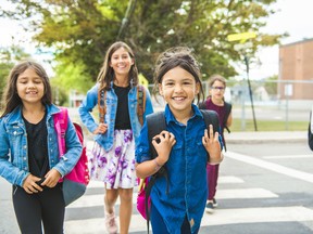 Maskless children outside a school.