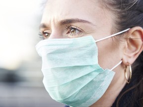 A woman is pictured in a mask during the pandemic