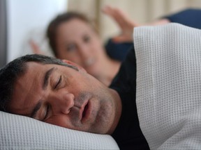 Woman suffers from her male partner snoring in bed.