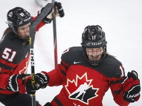 Canada's Ella Shelton, right, celebrates her goal with teammate Canada's Victoria Bach during second period IIHF Women's World Championship hockey action against Russia in Calgary, Alta., Sunday, Aug. 22, 2021.