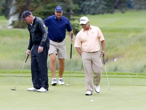 Golfers (left to right) Frank Lickliter, Dennis Hendershott, and Omar Uresti practice during the SHAW Charity Golf Classic at the Canyon Meadows Golf and Country Club in Calgary on Tuesday.