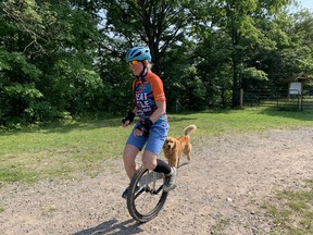 Joey (Joanne) Kirkwood is riding a unicycle to raise funds for SickKids Foundation. Photographed in Sault Ste. Marie, Ont., on Wednesday, Aug. 18, 2021 at Hiawatha with her furry pal Zumi. (DANIELLE DUPUIS/THE SAULT STAR/POSTMEDIA NETWORK)