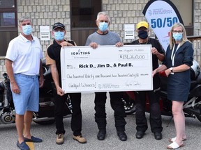 Chatham-Kent Health Alliance Foundation vice-chairperson Bob Hockney, far left, and president and CEO Mary Lou Crowley, far right, present a cheque to 50/50 draw winners Rick De Marse, second from left, James Desjardins and Paul Ballay in Chatham, Ont., on Tuesday, Aug. 17, 2021. (Contributed Photo)