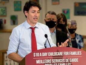 Prime Minister Justin Trudeau speaks to members of the media as Prince Edward Island Premier Dennis King watches at the daycare inside Carrefour de l'Isle-Saint-Jean school in Charlottetown, P.E.I., July 27, 2021.