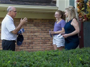 Conservative party candidate Rob Flack speaks with Dianne Springmann and her 13-year-old granddaughter Claudia Arthur while door-to-door campaigning in the London West riding on Monday. (Derek Ruttan/The London Free Press)