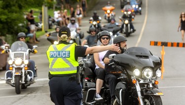 OPP were directing bikes and cars in a loop around the Main Street in Port Dover on Friday 13th which was closed to motorcycles and cars to give pedestrians more room to move around as a COVID-19 precaution.

(Mike Hensen/Postmedia Network)