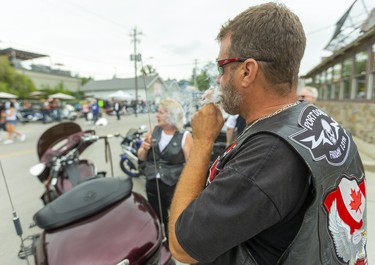 Ron Humphrey and his wife Jenn from Sarnia enjoy the sights in  Port Dover on Friday 13th. 

(Mike Hensen/Postmedia Network)