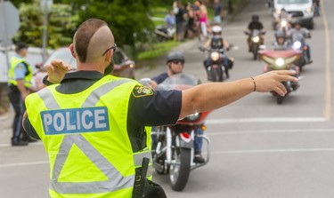 Jay White an OPP officer directs traffic in Port Dover on the Friday the 13th biker rendezvous in the small port town.

Sgt. Ed Sanchuk, of the OPP gave an estimate of 30-35,000 attendance down from pre-COVID meetups of over 100,000 in the town.

(Mike Hensen/Postmedia Network)