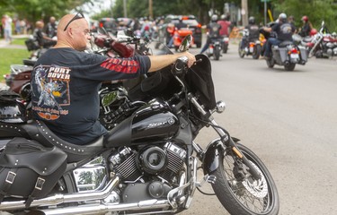 Kevin Brockbank of Hamilton settles in on his bike to watch the unending parade of bikers cruising through the small town of Port Dover during the Friday the 13th biker rendezvous. 
(Mike Hensen/Postmedia Network)