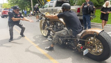 Michael Buchkovsky of Toronto, cannot believe his eyes as he asks in delight, "what is it," as Giusseppe Agrippa of Vaughan rolled up in his fully custom built 3 cylinder diesel chopper had the crowd at Port Dover enthralled.

(Mike Hensen/Postmedia Network)