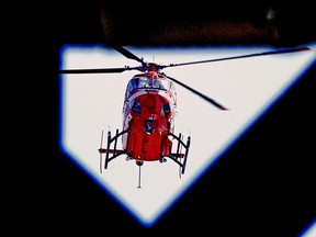 A STARS air ambulance helicopter is framed by a girder on the High Level Bridge in Edmonton on Tuesday April 6, 2021.