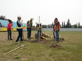 Workers from K.I. International, EllisDon Construction, and Contour Earthmoving Ltd. are hard at work installing a new horseshoe pit for the residents of the Luxstone Manor. Photo by Riley Cassidy/Airdrie Echo/Postmedia Network