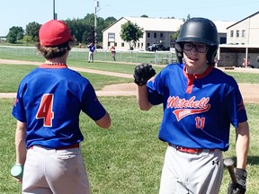 Keegan Priestap (right) of the Mitchell 15U Ontario baseball entry, is congratulated by teammate Jarrett Van Bakel (4) during provincial playdown action at Kinsmen Park Aug. 14. The Astros swept a doubleheader, beating Exeter and Beamsville, to qualify for the OBA 'D' final playdowns. ANDY BADER/MITCHELL ADVOCATE