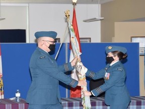Colonel M.C.G. Lehoux (R) hands the 434 Squadron colours to incoming commanding officier LCol Matthew Parsons (L). SUBMITTED PHOTO