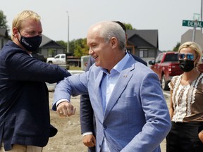 Federal Conservative Leader Erin O'Toole bumps elbows with Bay of Quinte candidate Ryan Williams as O'Toole arrives for a news conference Monday on Dewal Place in Belleville's west end. At right is Hastings-Lennox and Addington candidate Shelby Kramp-Neuman.