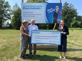 Husband and Wife John and Penny Conley present a cheque for $10,600 to Shannon Coull, executive director of the PECMH Foundation, at the future site of QHC Prince Edward County Memorial Hospital. Photo submitted by Briar Boyce.