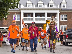Rocky Commanda (second from left) was among more than 100 people departing the Mohawk Institute in Brantford on Friday August 27, 2021 on the first day of the three-day memorial Walk for Joe. As children, Joe and Rocky were taken from their home on the Pikwakanagan First Nation near Pembroke in the 1960s and placed at the residential school in Brantford.