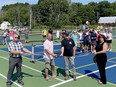 The Town of Gananoque officially opened the new multi-use sports courts on Friday. From left to right, Robert Kennedy, superintendent of parks and facilities, Coun. Mike Kench, Mayor Ted Lojko and CAO Shellee Fournier cut the ribbon to officially open the new multi-use Gananoque Sport Courts. Tennis Club members, youth basketball club members and Gananoque Pickleball Club players joined town staff at the opening.(SUBMITTED PHOTO)