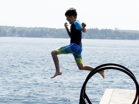 Seven-year-old Cameron Owen prepares to block his nose on the way into the refreshing St. Lawrence River at Centeen Park on Friday. The heat was expected to continue into this week. (RONALD ZAJAC/The Recorder and Times)