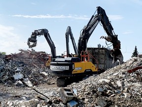 Workers use heavy equipment to remove the rubble from the site of the former St. Vincent de Paul Hospital on Wednesday, after the last standing structure was torn down earlier in the day. (RONALD ZAJAC/The Recorder and Times)