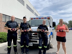 From left, paramedic supervisor Chris Scott and paramedics Colin Anderson and Lindsey Lowe pose with Tamara Baldwin, interim chairwoman of the Brockville Municipal Drug Strategy group, to display new naloxone kits paramedics will distribute to members of the public. (RONALD ZAJAC/The Recorder and Times)