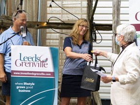 Tamara Phillips and Kevin Quinlan, owners of Westport Brewing Company, accept a Leeds Grenville bag during the Digital Main Street funding launch for the United Counties of Leeds and Grenville on Thursday.