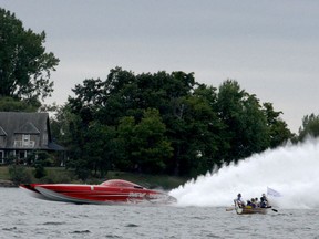 The iconic powerboat My Way roars out of Gananoque after the 1000 Islands Gananoque Poker Run on Saturday afternoon, while canoeists from the Thousand Islands Boat Museum look on. (RONALD ZAJAC/The Recorder and Times)