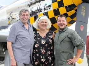 Owner Peter Timmermans (left) of Blenheim, his wife Annie, and pilot Mackenzie Cline bring a P-51 Mustang to the Chatham-Kent Municipal Airport in Merlin on Aug. 7. Mark Malone/Postmedia Network