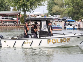 Members of the OPP underwater search and recovery unit head to Lake Erie out of South Side Landing Marina & RV Park in Erieau on Sunday. They were searching for a boater since Friday morning. Mark Malone