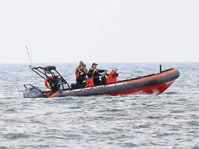 Chatham-Kent firefighters search the waters of Lake Erie near the south point of Rondeau Provincial Park on Aug. 7. Mark Malone