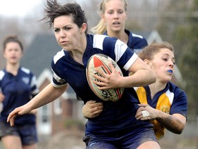 Ursuline Lancers' Alicia Dalanyi is tackled by Chatham-Kent Golden Hawks' Katelynn Ayoub during a Kent high school girls rugby game at Ursuline on April 7, 2011 in Chatham. File photo/Postmedia Network