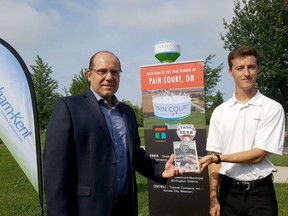 Rob Bernardi (left), director of engineering and compliance for the Chatham-Kent public utilities commission, accepts an award recognizing the Pain Court water tank from Cameron Walker, of Tnemec, on Aug. 26. The tank was the top Canadian entry in the North America-wide tank of the year competition. Trevor Terfloth/Postmedia Network