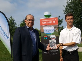 Rob Bernardi, director of engineering and compliance for the Chatham-Kent public utilities commission, left, accepts an award recognizing the Pain Court water tank from Cameron Walker, of Tnemec, on Thursday. The tank was the top Canadian entry in the North America-wide tank of the year competition. (Trevor Terfloth/The Daily News)