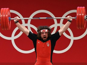 Sarnia's Boady Santavy reacts while competing in the men's 96-kg weightlifting competition during the Tokyo Olympic Games on Saturday at the Tokyo International Forum. Luis Acosta/AFP via Getty Images